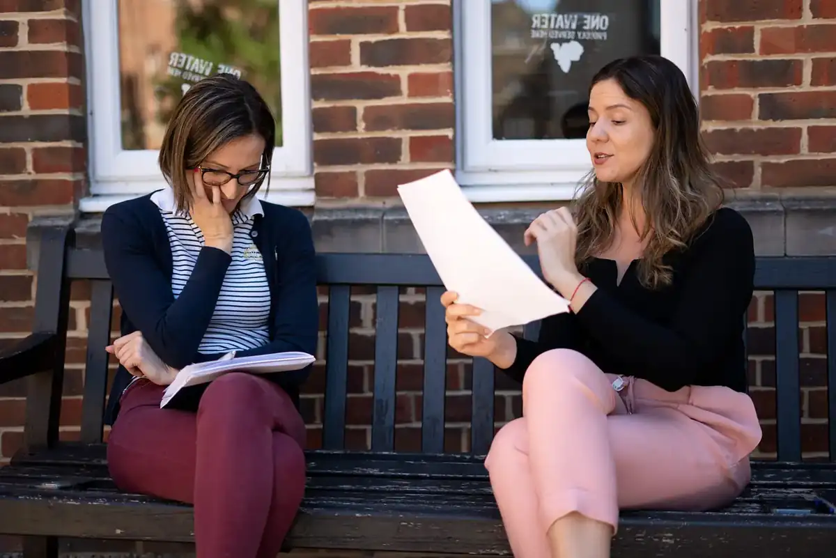 A tutor and student reviewing a research draft