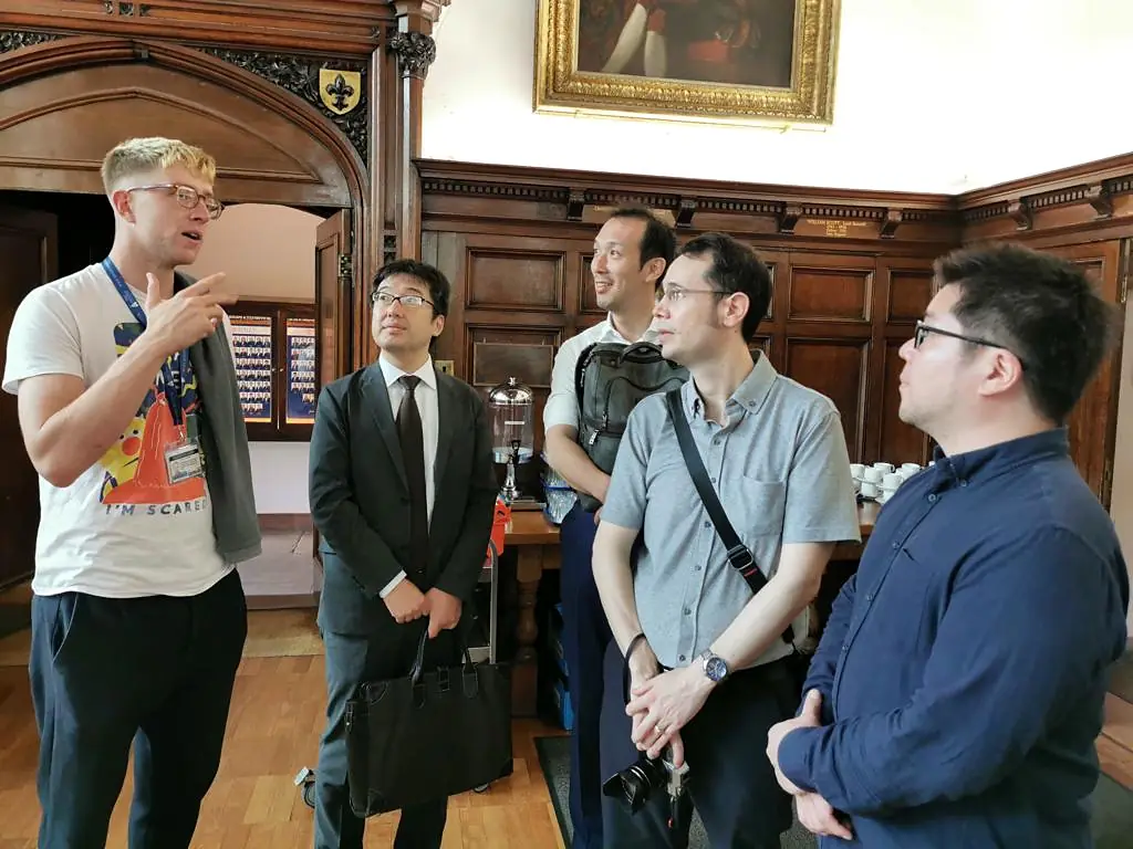 Discussion in a panelled hall